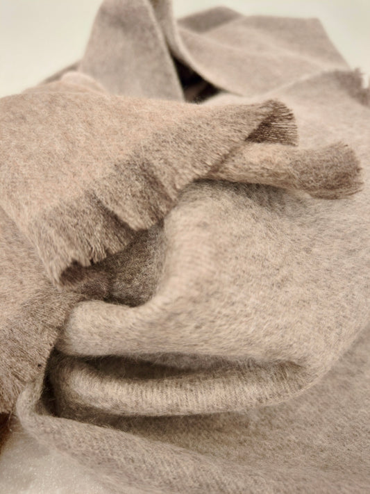 Soft close up of a taupe pure cashmere brushed scarf with a plush, cloud like texture. Displays the smooth drape, lightweight warmth, and natural variation of high quality Duo Plus cashmere.