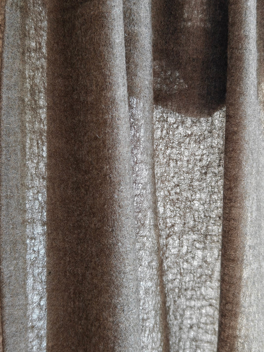 Close up of a natural brown cashmere shawl featuring a soft brushed texture, rich fiber detail, and warm earthy tones. The draped cashmere fabric highlights the quality, thickness, and artisanal character of this premium wrap.