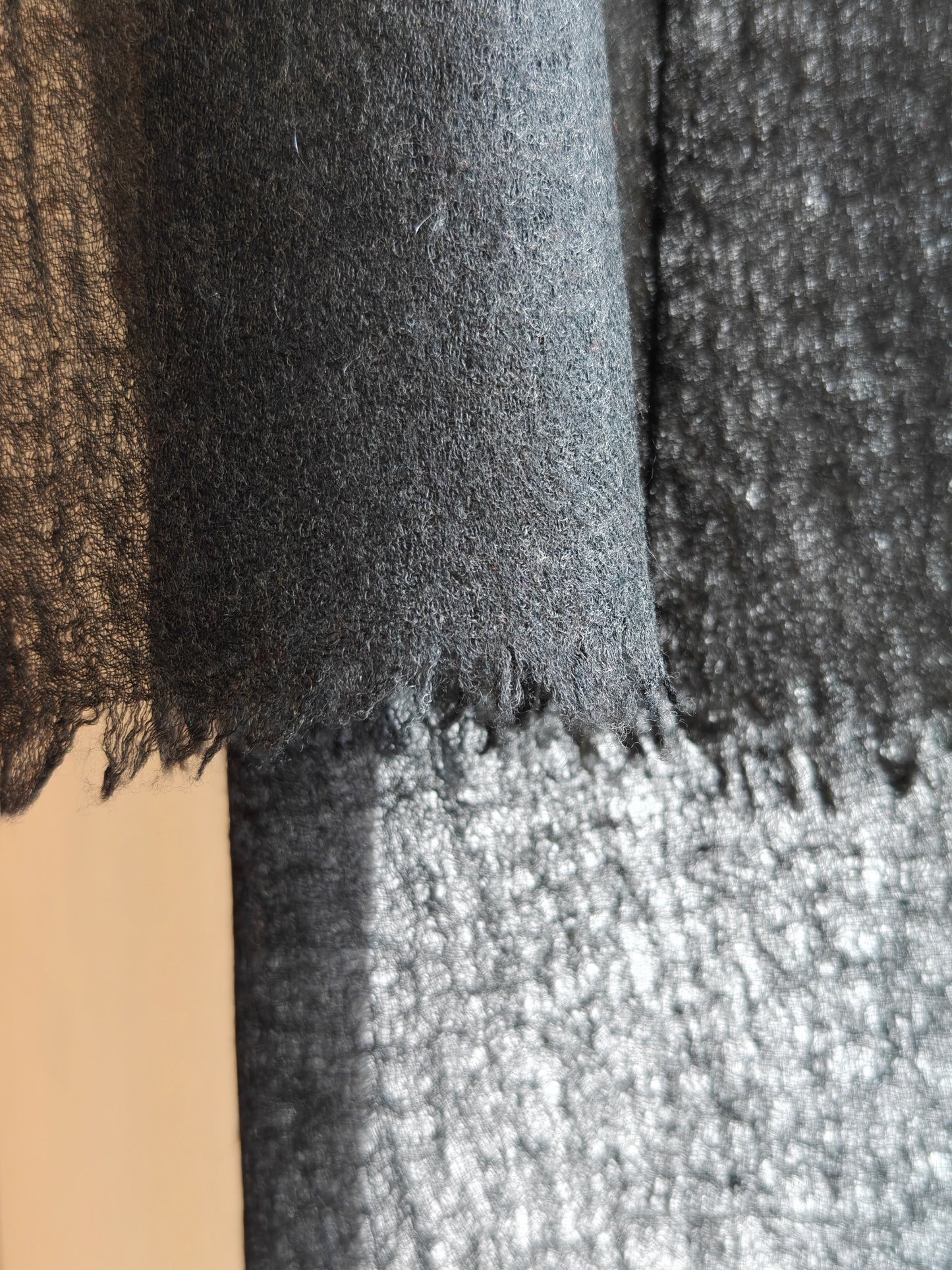 Detailed close up of the soft brushed cashmere texture highlighting the lightweight open weave and premium long fiber quality.