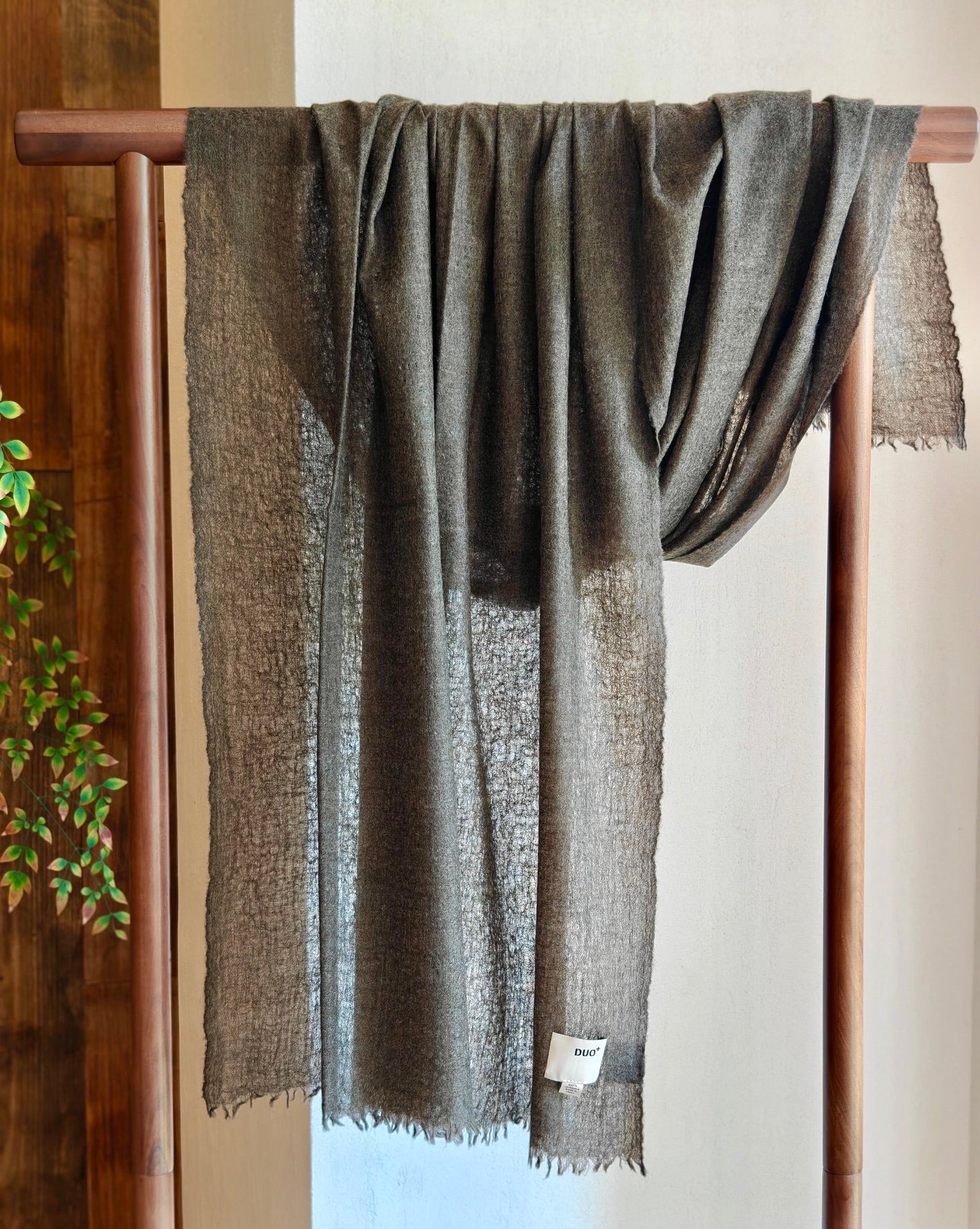 Lightweight charcoal cashmere wrap hanging to show sheer open weave and airy texture made from 100 percent Inner Mongolian cashmere