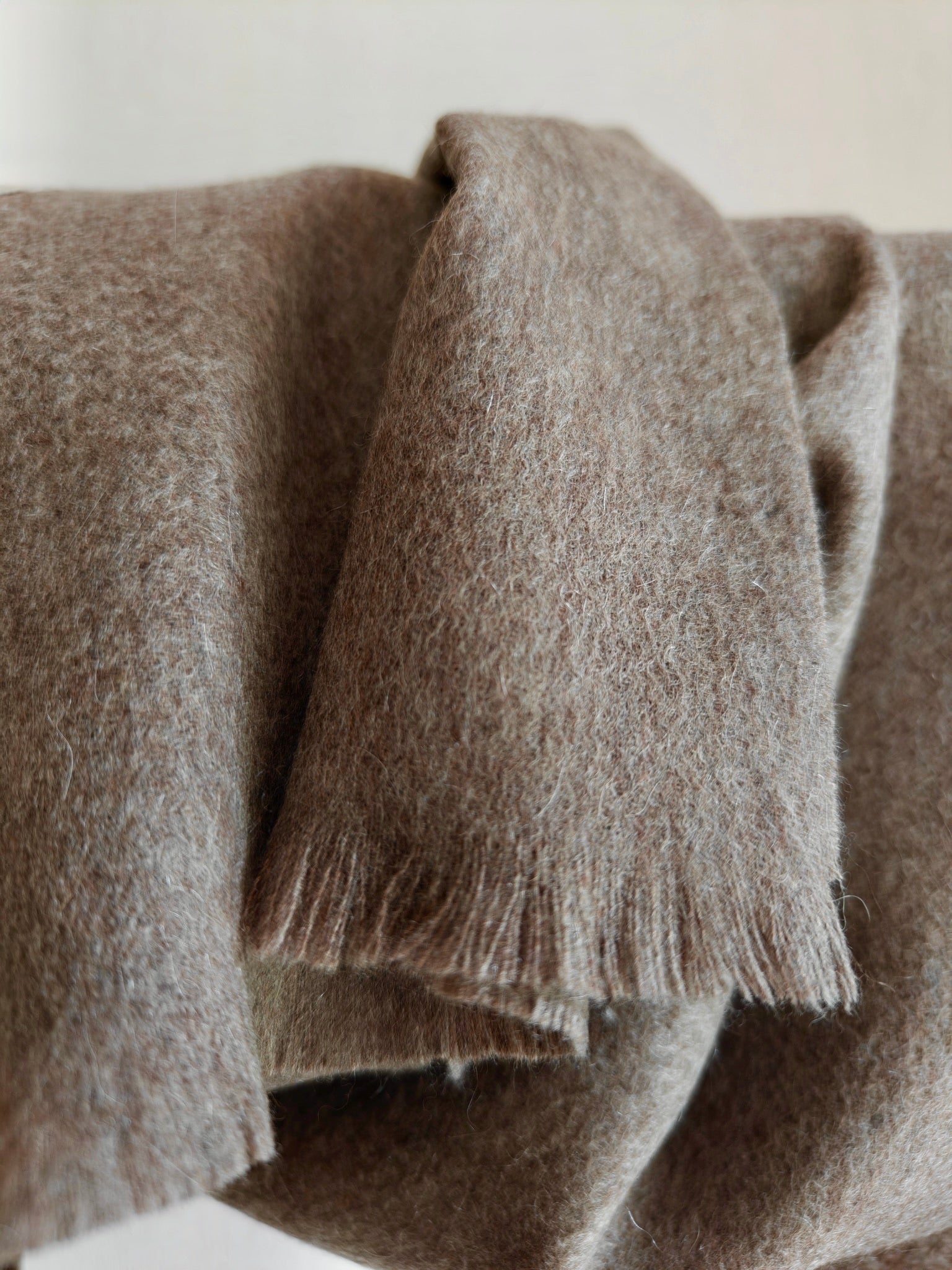 Close up of a brown pure cashmere brushed scarf from Duo Plus. Shows the soft airy texture, natural loft, and fine fibers of premium Inner Mongolian cashmere.