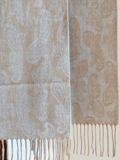 Pure cashmere paisley scarf hanging to show the full woven pattern and long fringe detail. Features a refined beige and blue palette crafted from soft Inner Mongolian cashmere.