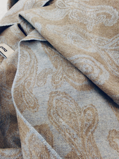 Pure cashmere paisley scarf displayed in a relaxed draped style, highlighting the smooth hand feel and reversible beige and blue woven design. Premium Inner Mongolian cashmere from Duo Plus.