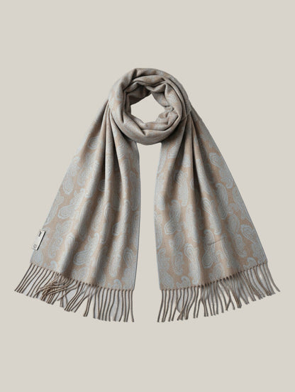 Studio product shot of a pure cashmere paisley scarf in beige and blue with long draped panels and fringe edges. Luxurious winter accessory crafted from fine Inner Mongolian cashmere.
