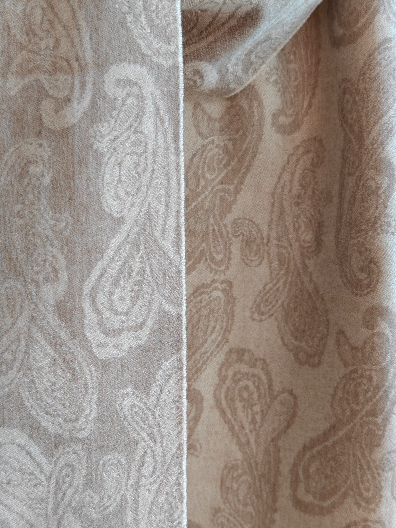 Detailed view of the pure cashmere paisley pattern in a taupe beige colorway. Displays the reversible design, fine craftsmanship, and the natural sheen of Duo Plus Inner Mongolian cashmere.