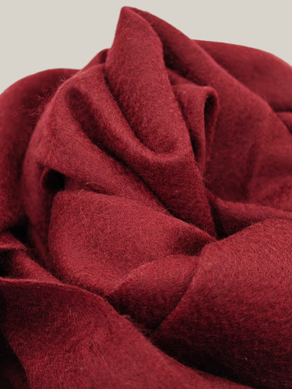 Close up of a red pure cashmere scarf from Duo Plus showing its soft brushed texture and rich warm tone. Highlights the premium Inner Mongolian cashmere fibers and luxurious hand feel.
