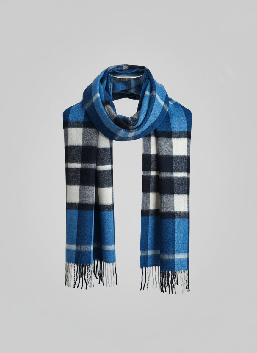 Studio style product shot of a slim blue plaid cashmere scarf with clean edges and soft brushed finish. Features navy, white, and charcoal accents woven in premium Inner Mongolian cashmere.