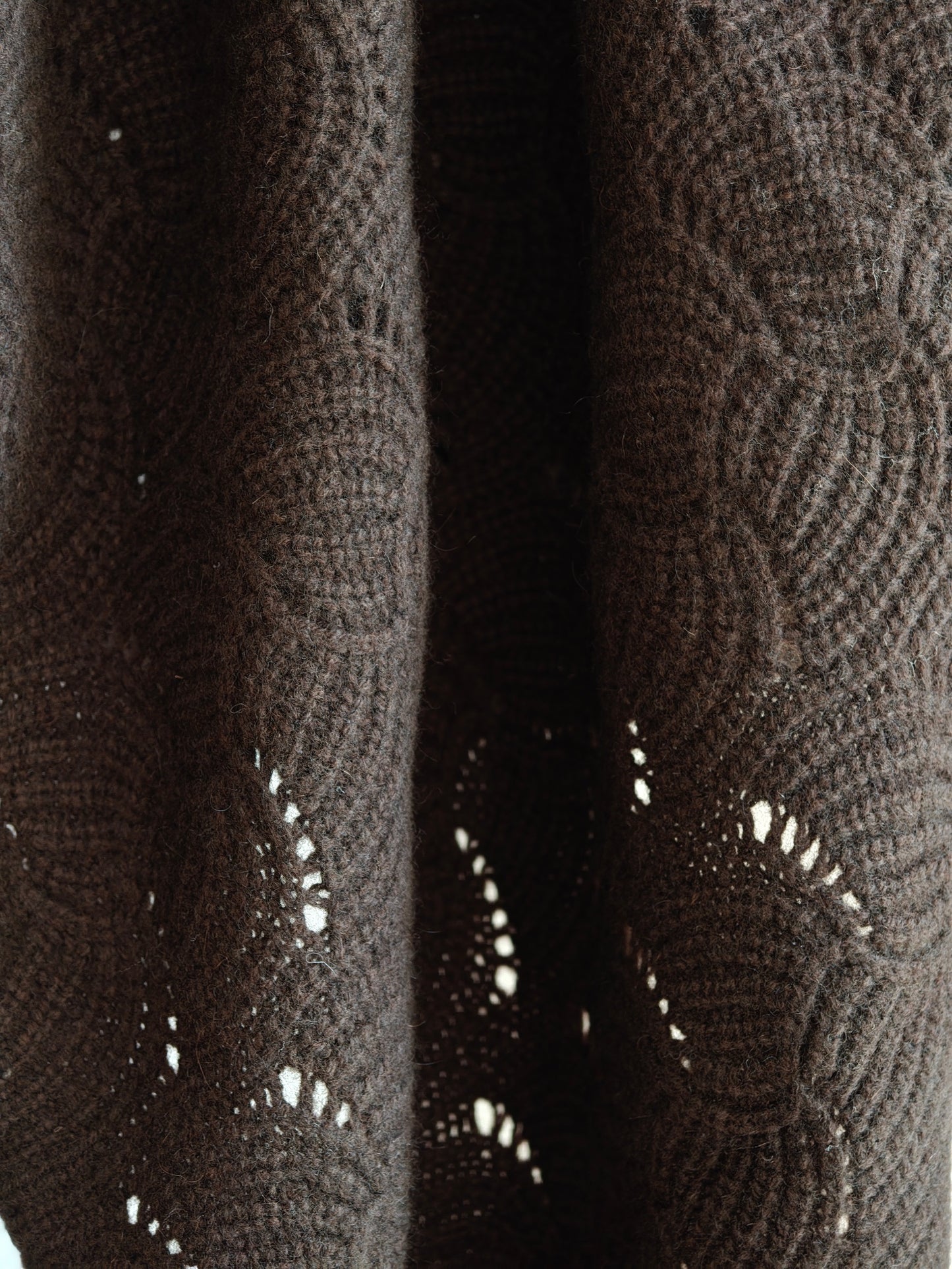 Hanging view of the yak wool shawl showing the natural movement and open knit texture. Soft, breathable, and richly colored for everyday styling.