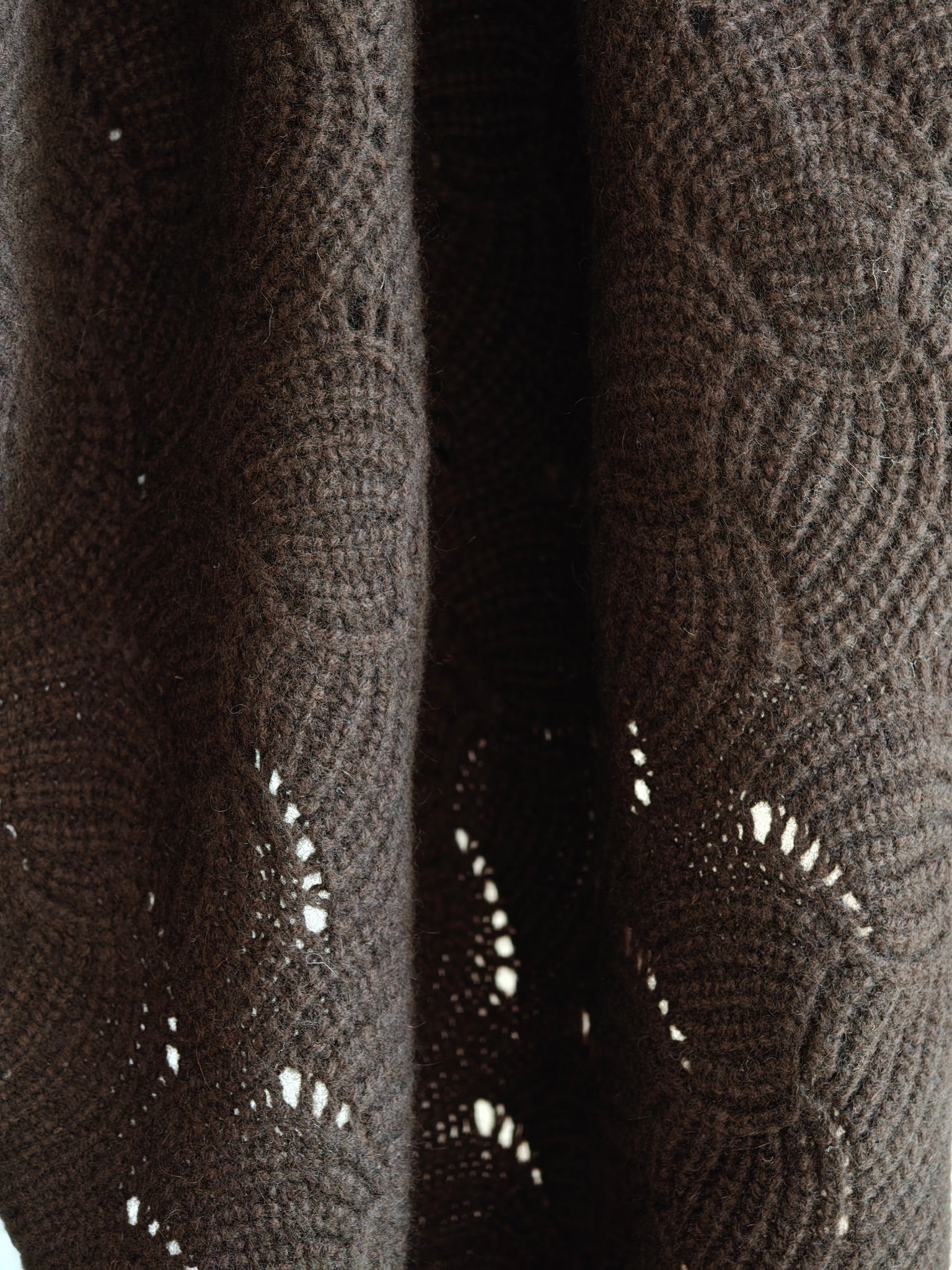 Hanging view of the yak wool shawl showing the natural movement and open knit texture. Soft, breathable, and richly colored for everyday styling.