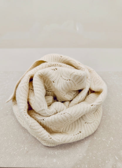 Ivory yak wool blend shawl neatly folded to show its soft drape and intricate open knit design. Ideal for showcasing material quality.