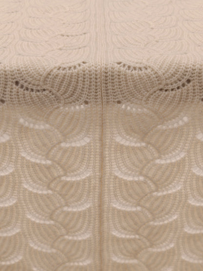 Full pattern view of the ivory yak wool blend shawl laid flat to highlight the scalloped knit structure and even stitching.